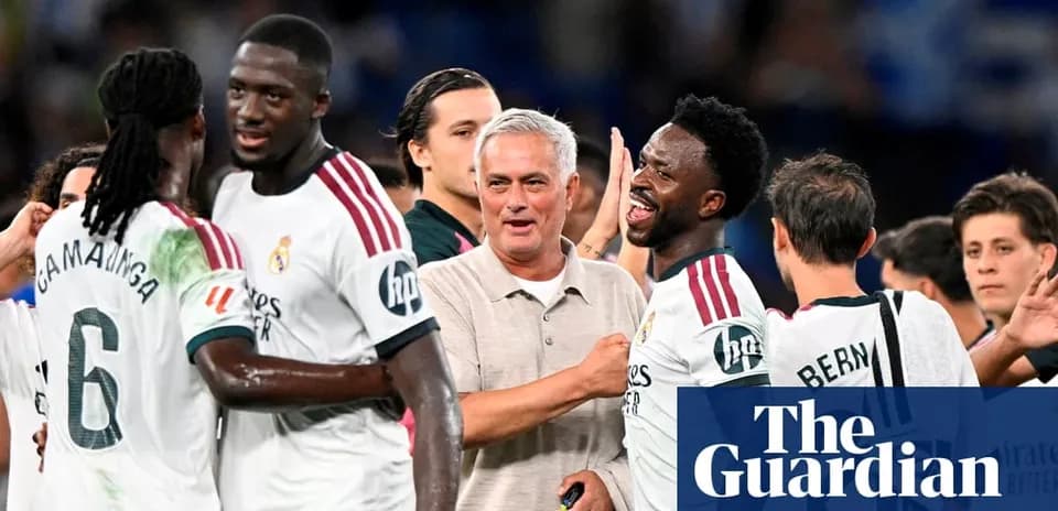 Players celebrating with manager after match victory