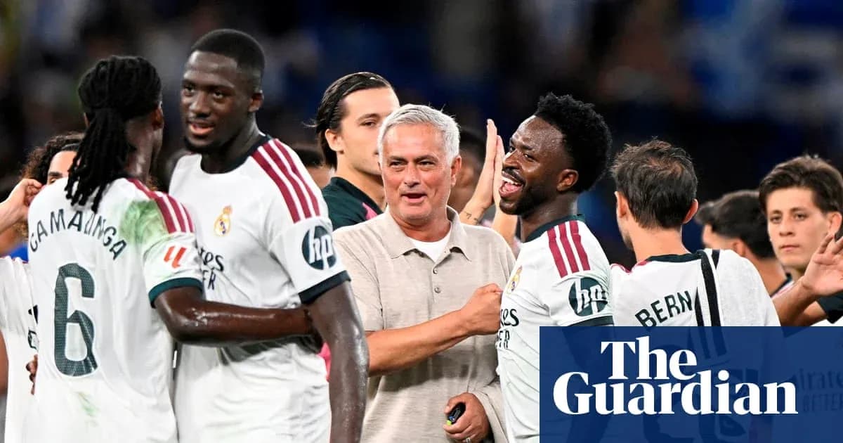 Players celebrating with manager after match victory