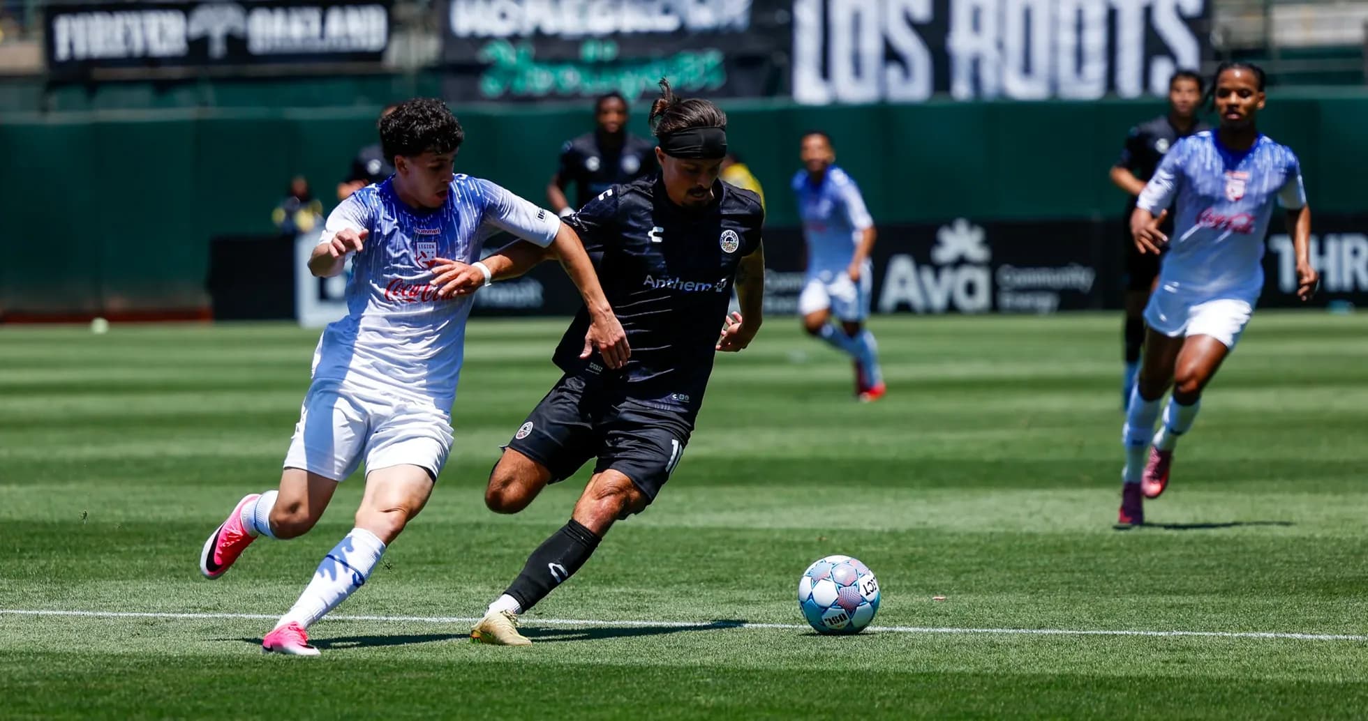 Oakland Roots player competing for the ball