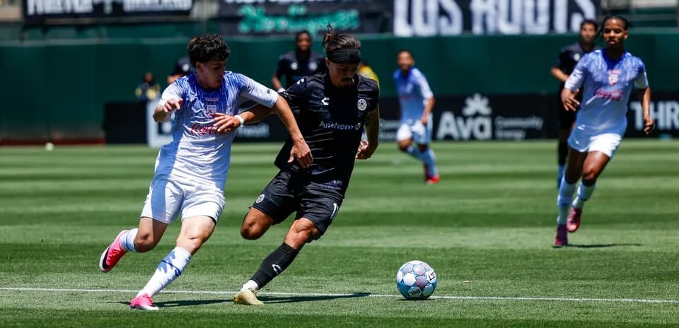 Oakland Roots player competing for the ball