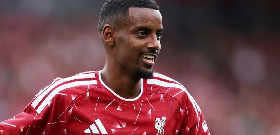 Player in Liverpool jersey smiling on the field