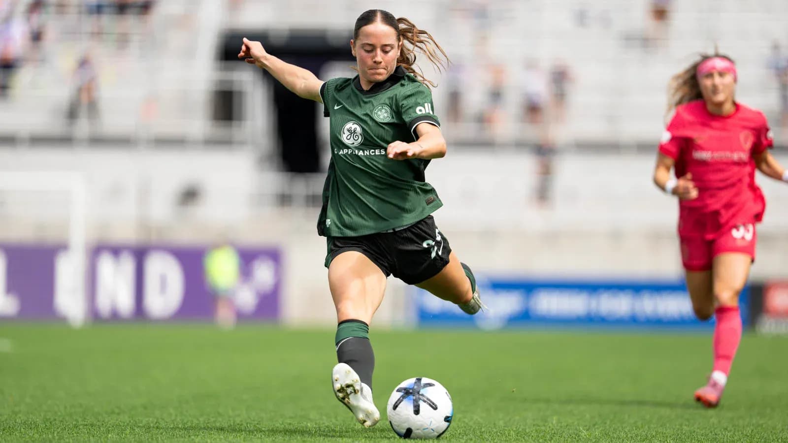 Player kicking the ball during NWSL match