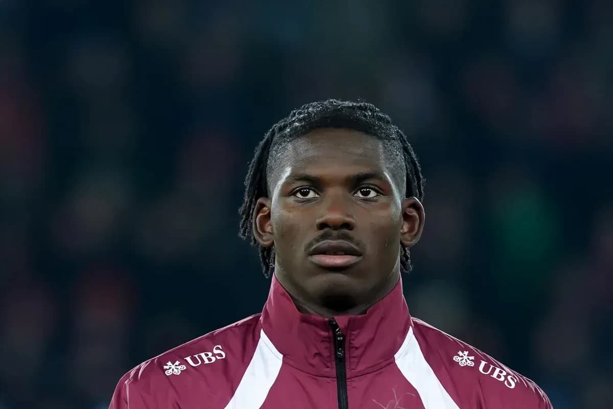 Player in maroon jacket during match preparation