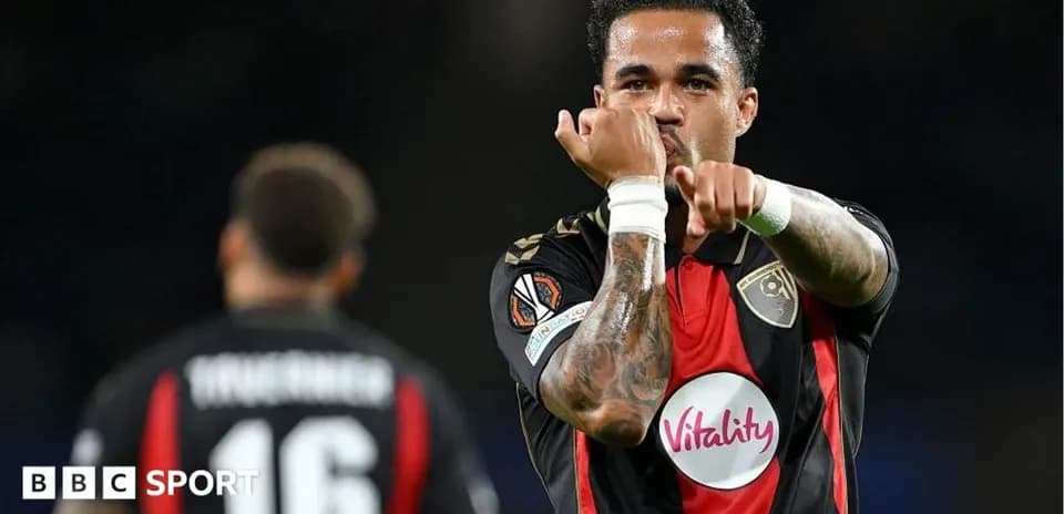 Player celebrating a goal with teammates in match