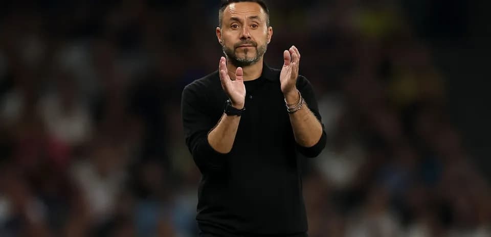 Coach clapping during a match on the sidelines