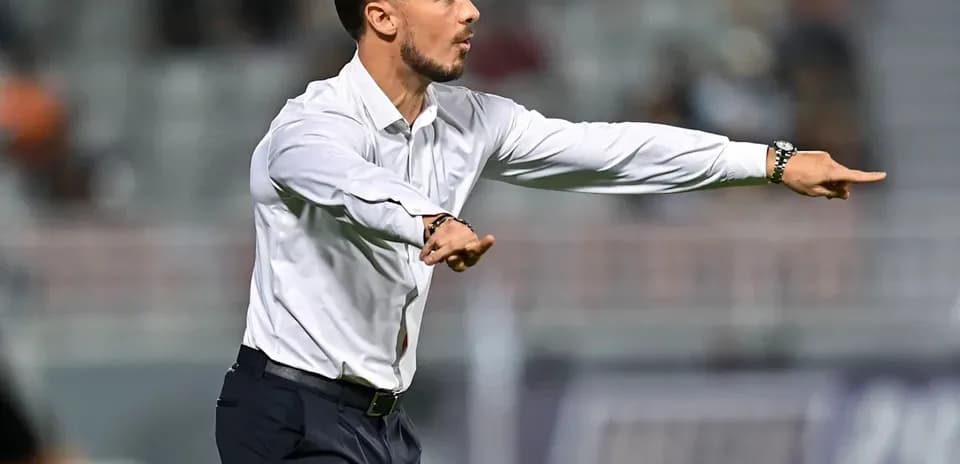 Coach giving instructions during a football match