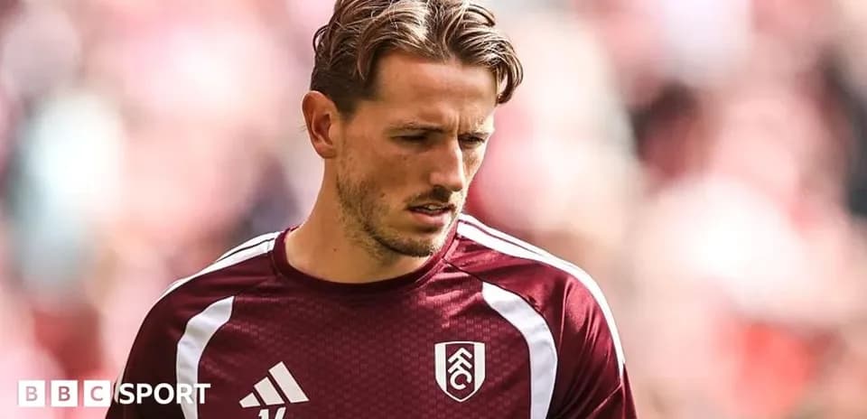 Player in Fulham kit warming up before match