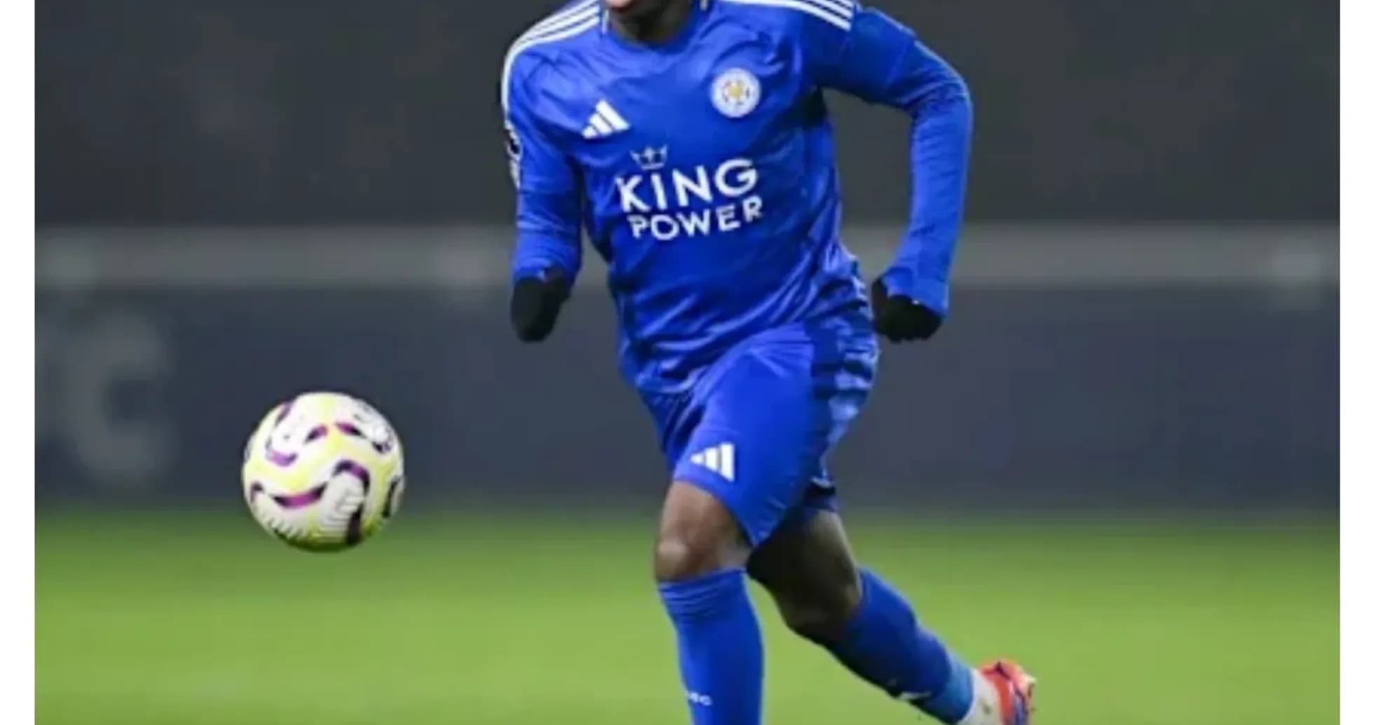Player in blue kit running with the ball