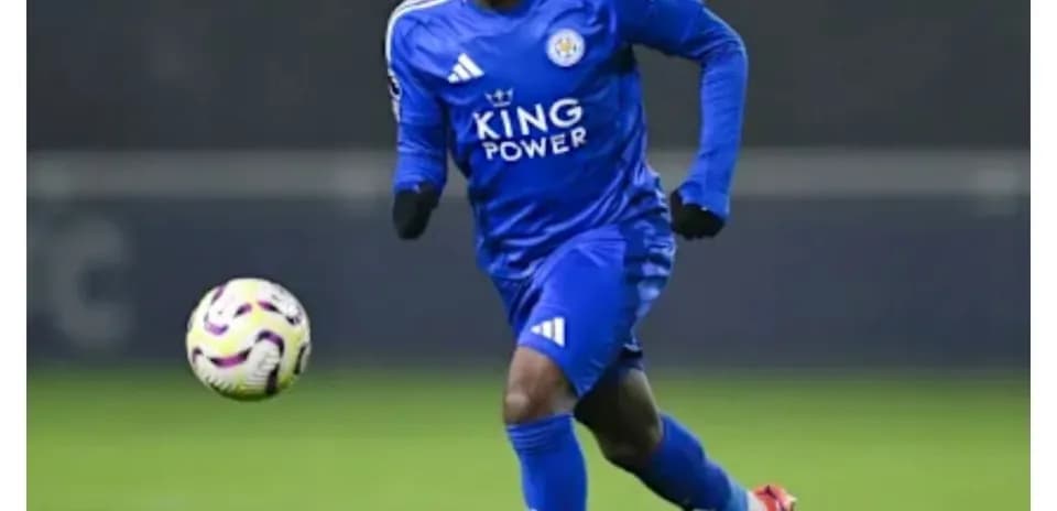 Player in blue kit running with the ball