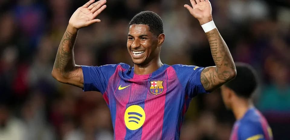 Barcelona player celebrating with raised hands on pitch