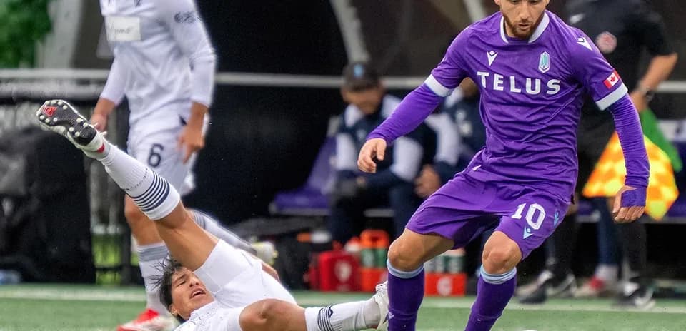 Player tackling opponent during Vancouver FC match