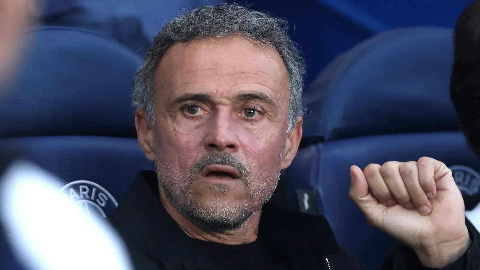 Coach observing from the sidelines during match