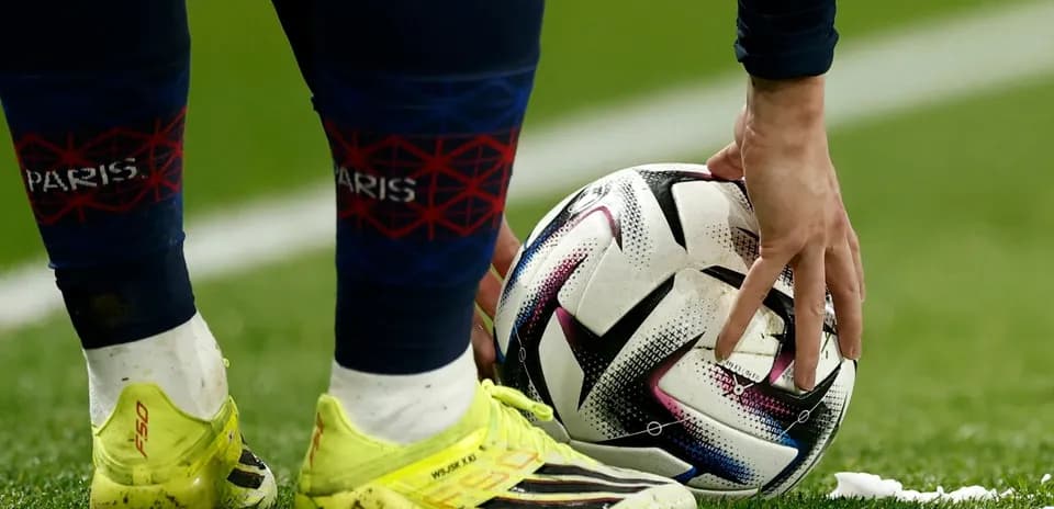 Player placing ball on the pitch for a kick