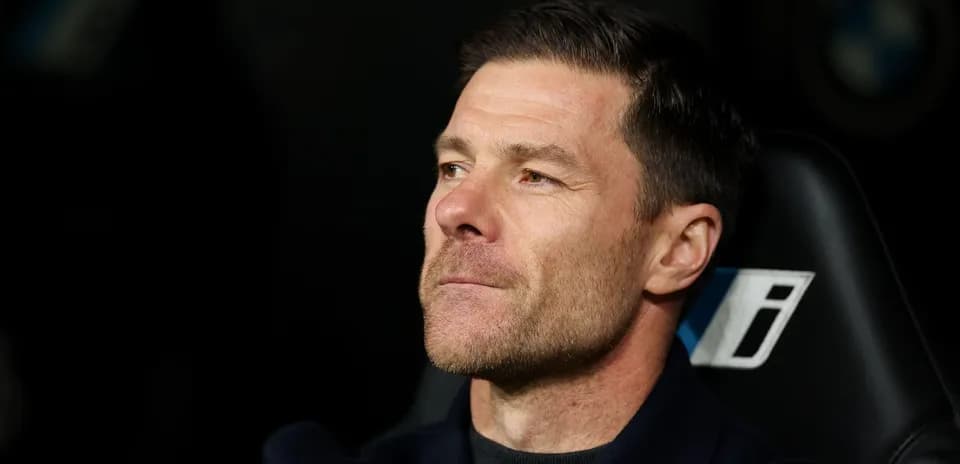 Coach seated on bench during a match