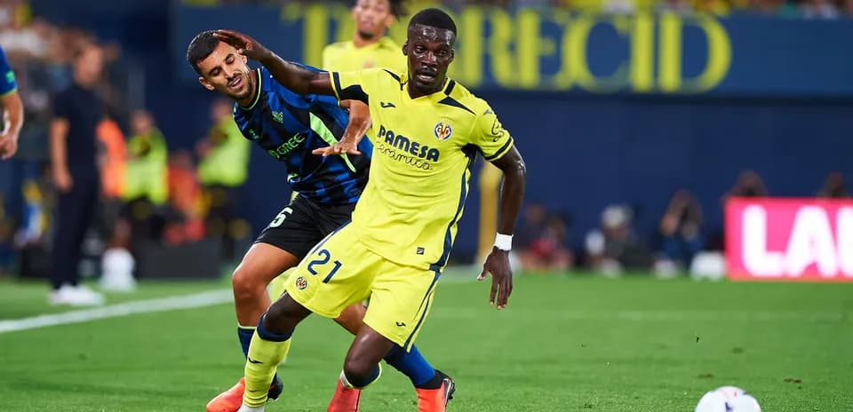 Player in yellow dribbling past opponent in blue