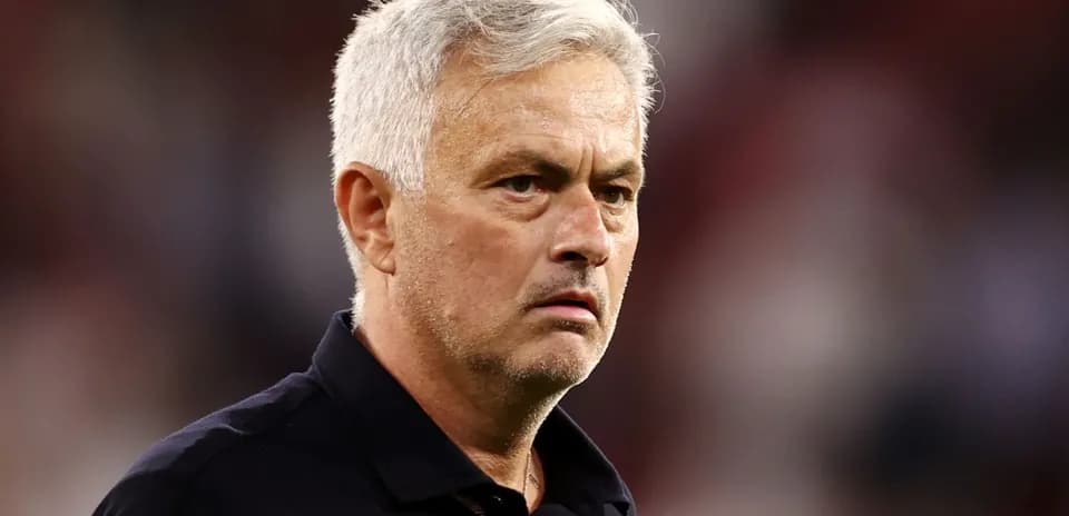 Coach observing match with focused expression
