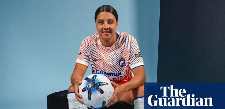 Player posing with a soccer ball in uniform