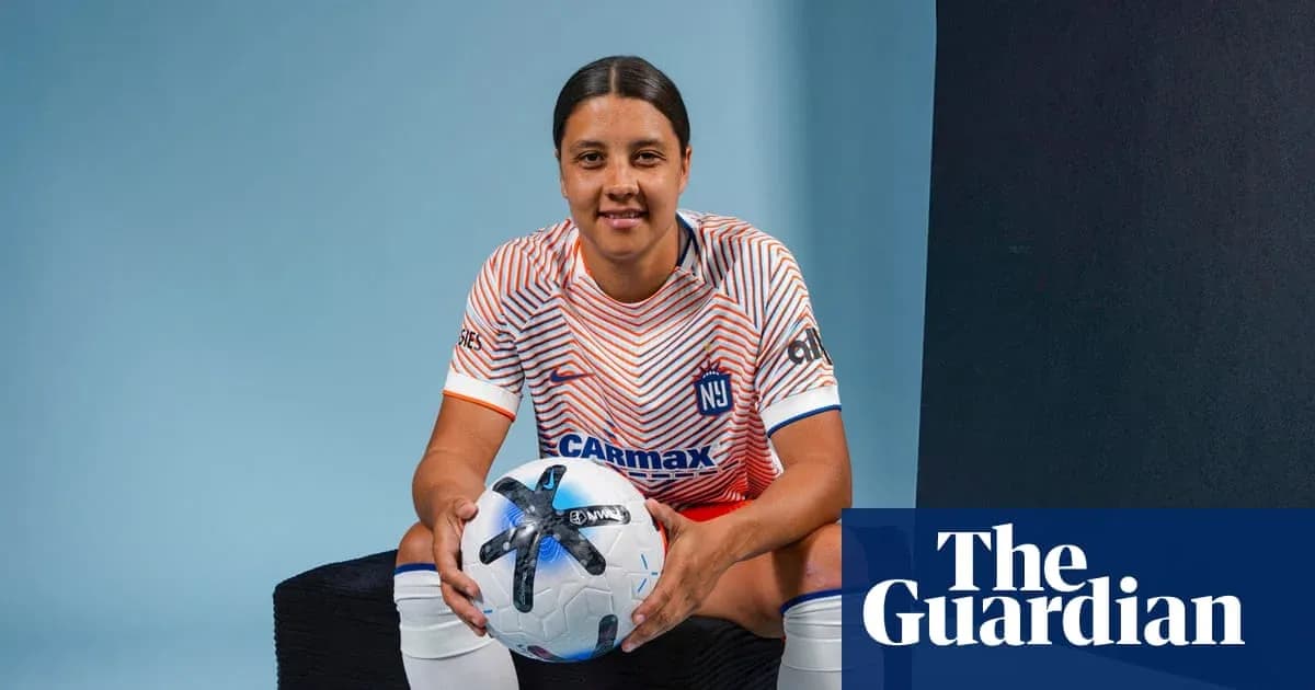 Player posing with a soccer ball in uniform