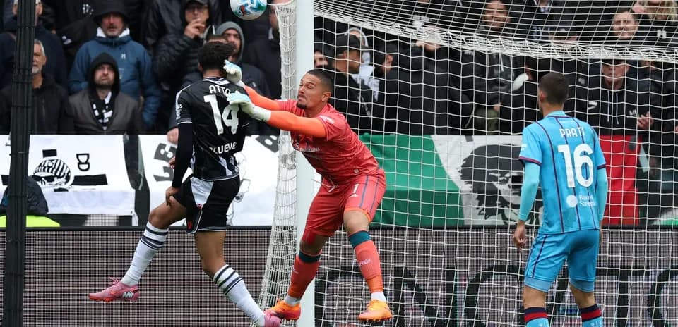 Goalkeeper attempting to block a shot during match