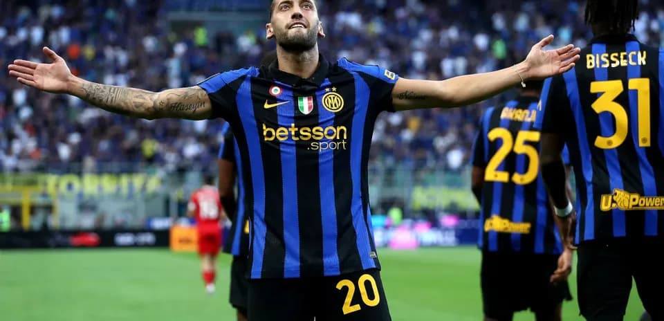 Player celebrating a goal with teammates at stadium