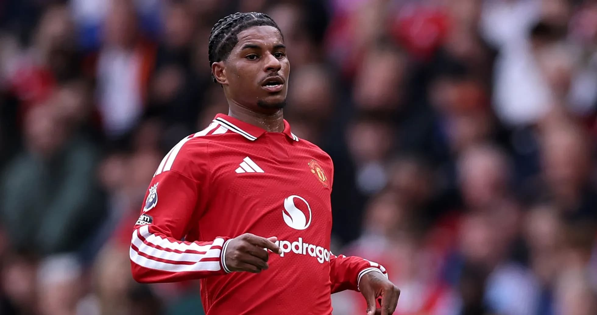 Player in red jersey running on the pitch