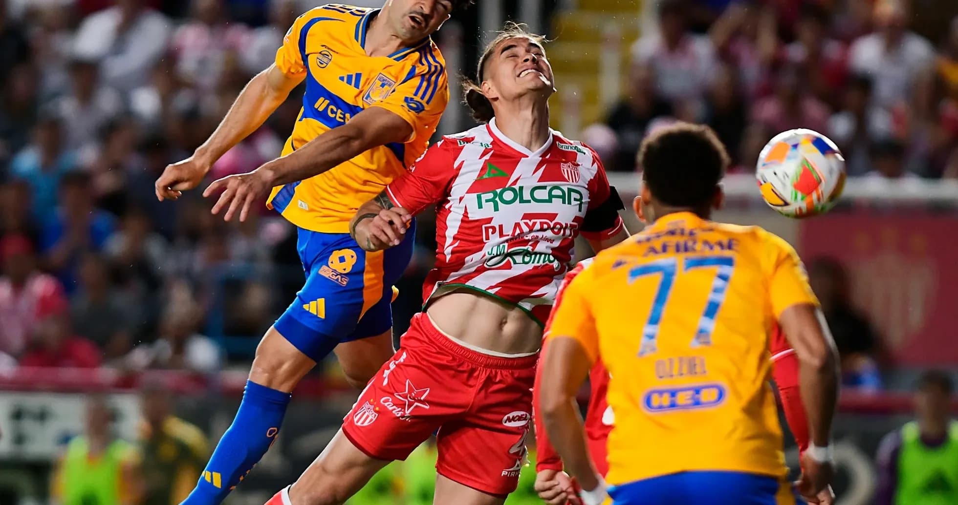 Players competing for the ball during Liga MX match