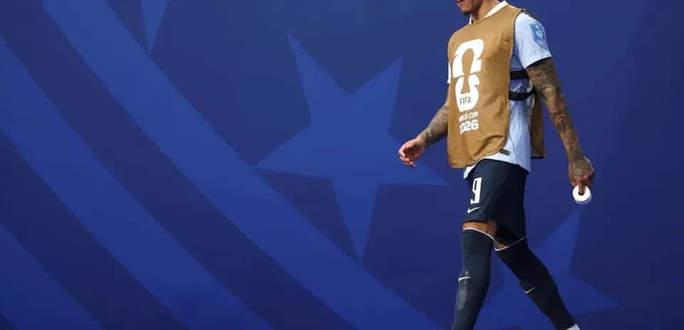Player walking on the pitch in warm-up attire