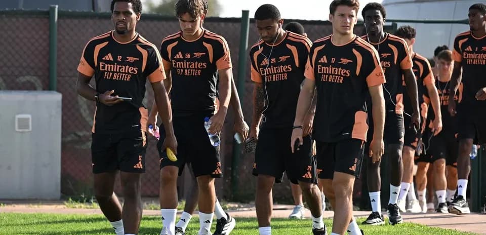 Arsenal players walking on training ground during session