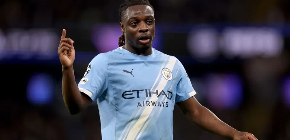 Player in Manchester City kit gesturing during match