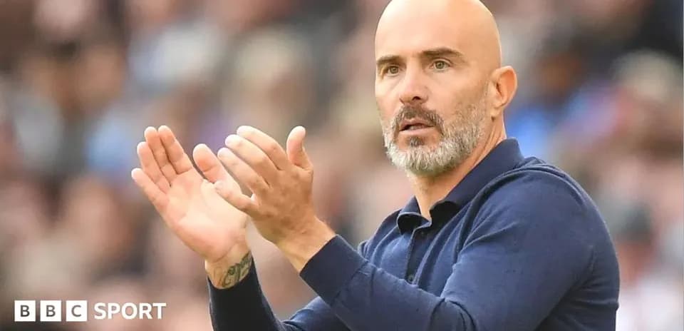 Coach gesturing and applauding during a match