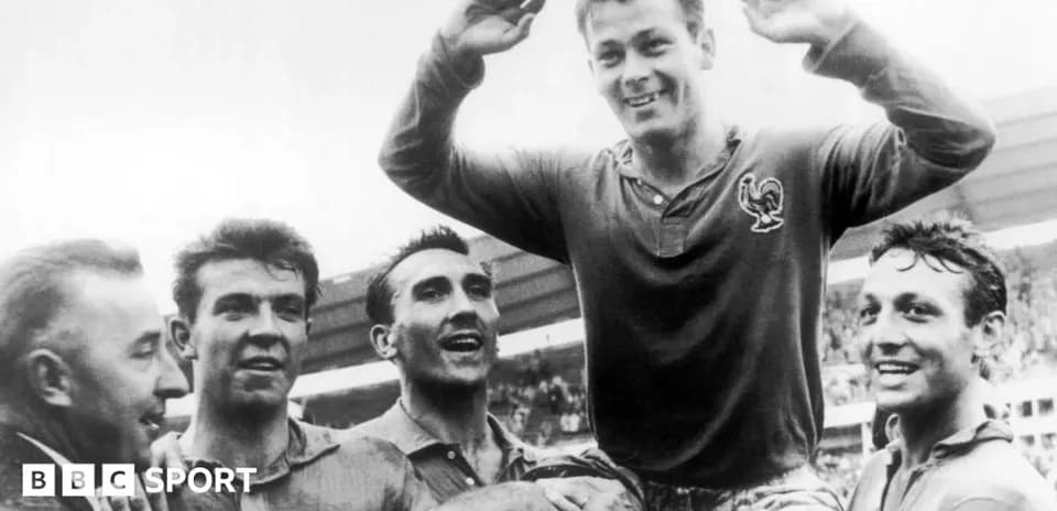 Players celebrating a victory, one being lifted up