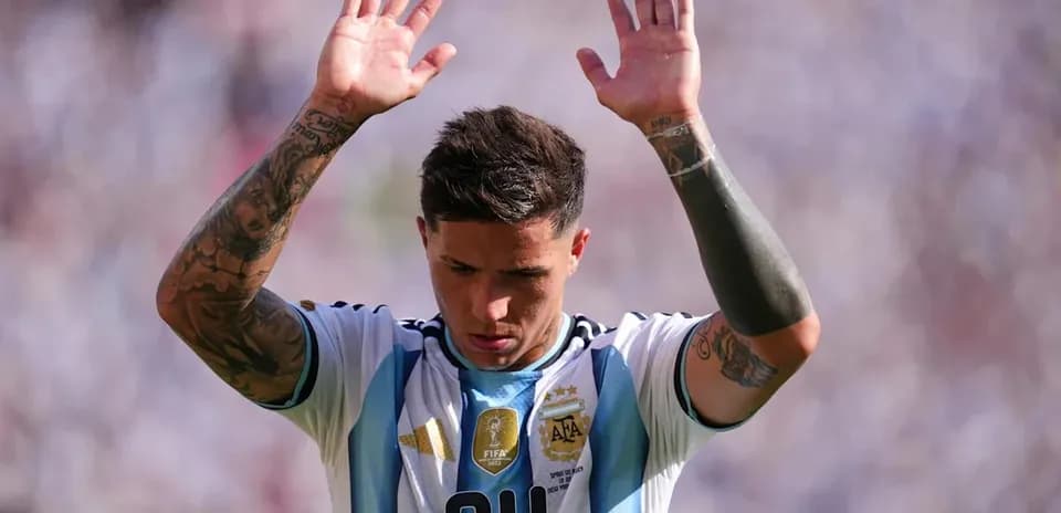 Player raising hands during a match in Argentina jersey