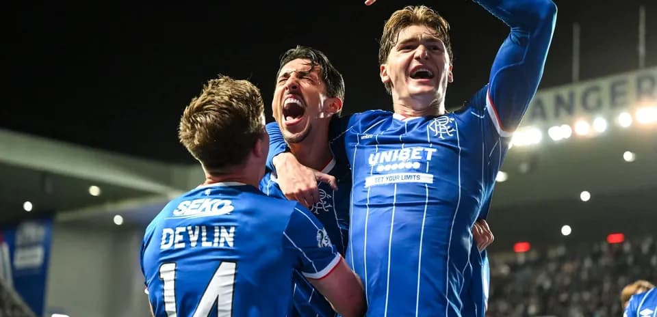 Rangers players celebrating a goal on the pitch