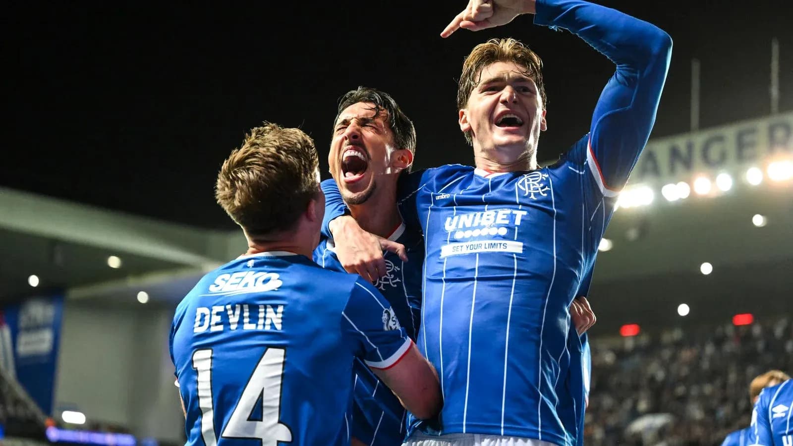 Rangers players celebrating a goal on the pitch