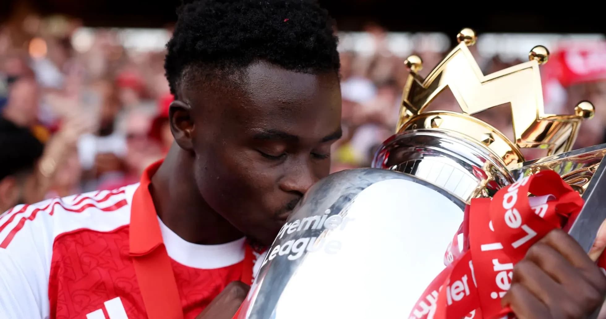 Player kissing Premier League trophy during celebration