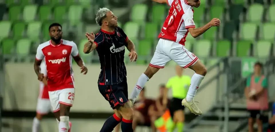 Crvena Zvezda player challenging for the ball