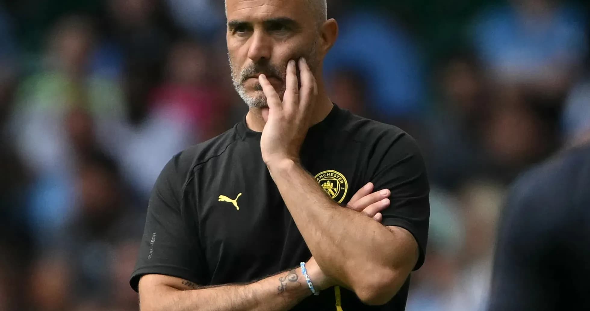 Manager observing the game with a thoughtful expression