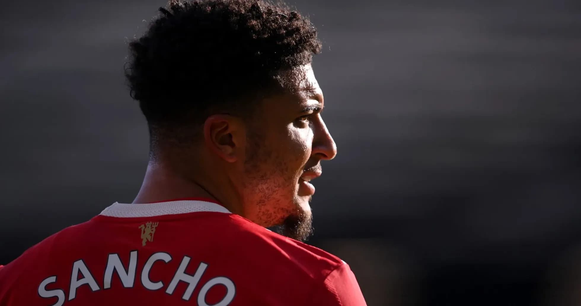 Player wearing red jersey with name 'SANCHO'