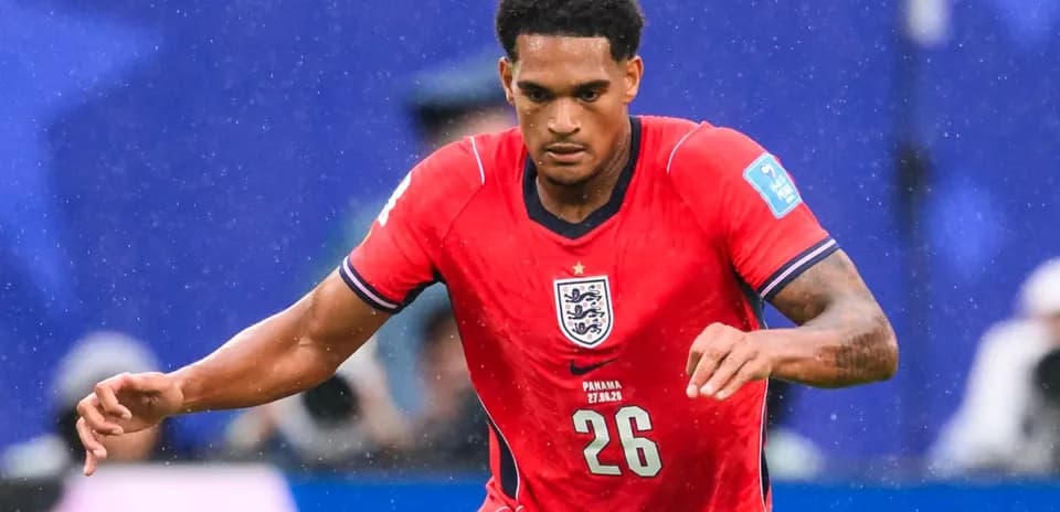 Player in red England kit running during match