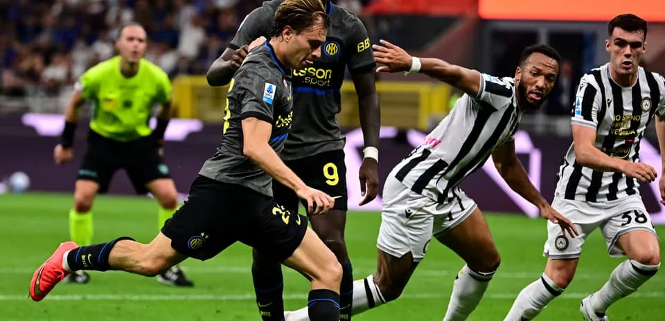 Player dribbling past opponents during match action