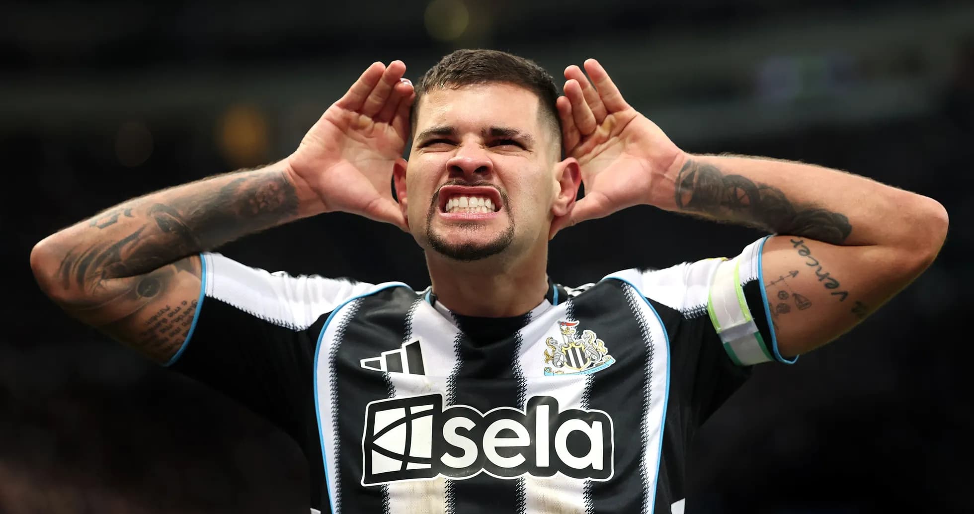 Player celebrating with hands on ears at stadium