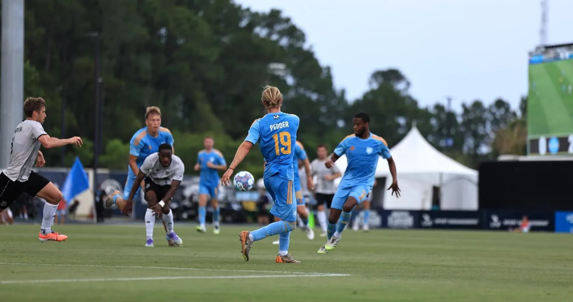 Player wearing number 19 passing the ball