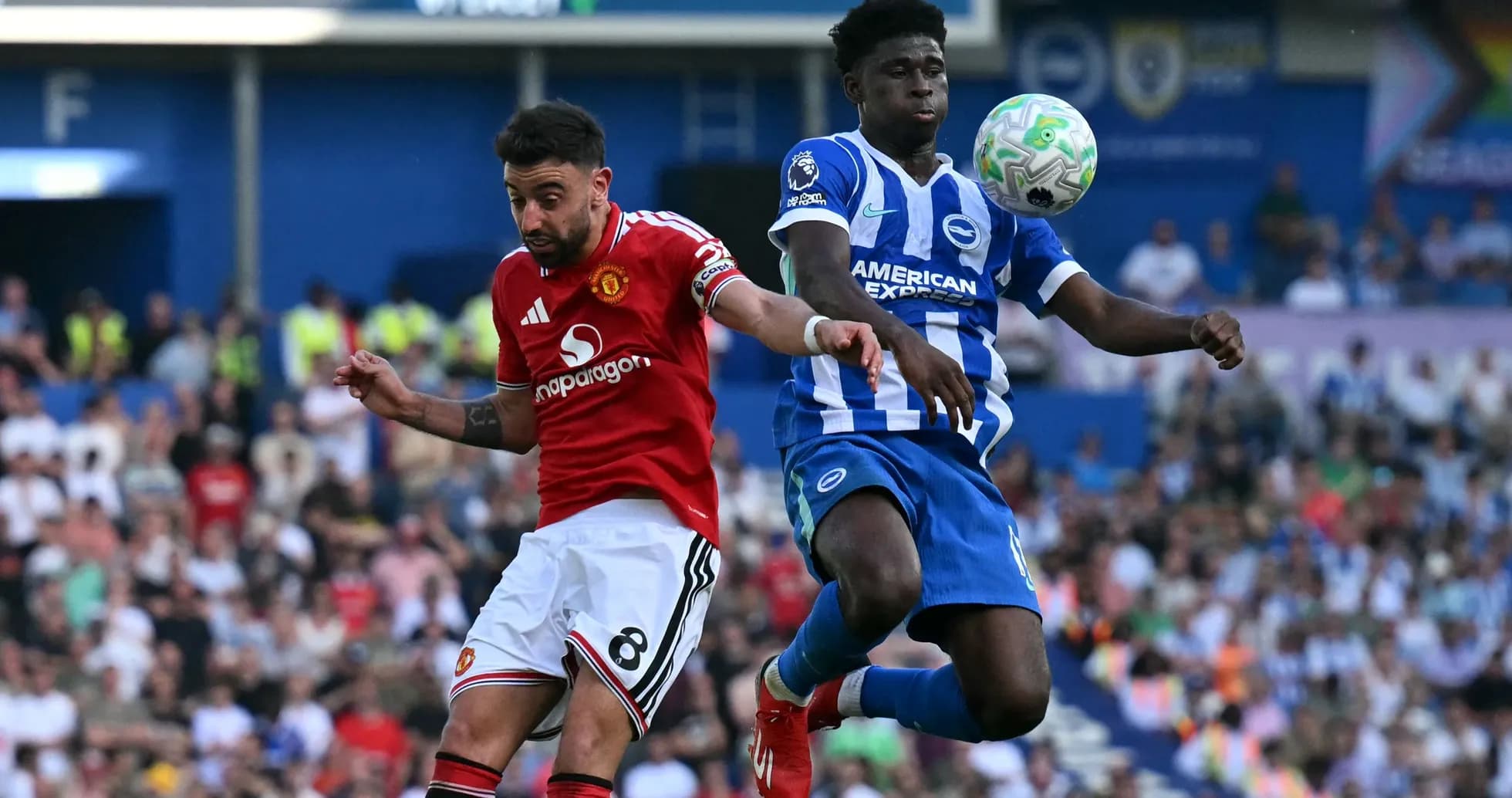 Player from Manchester United challenges Brighton player for ball