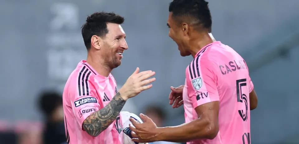 Two players celebrating a goal on the field
