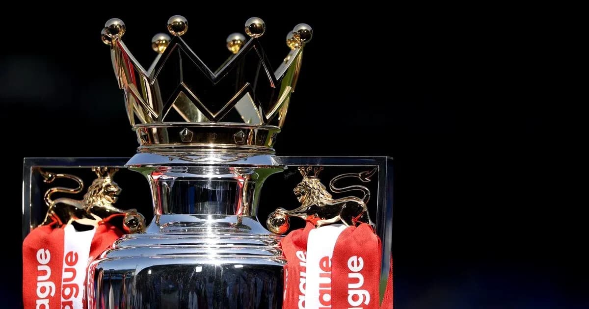 Premier League trophy with red ribbons displayed