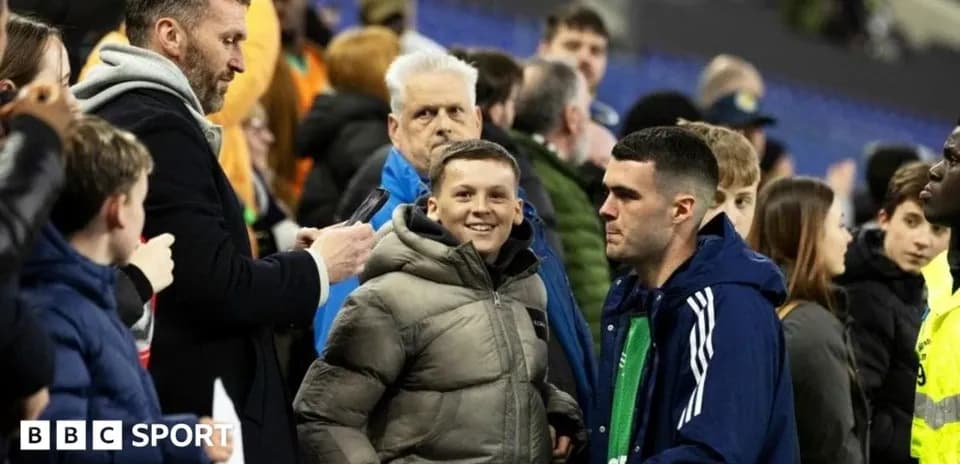 Fans interacting in the stadium stands after match