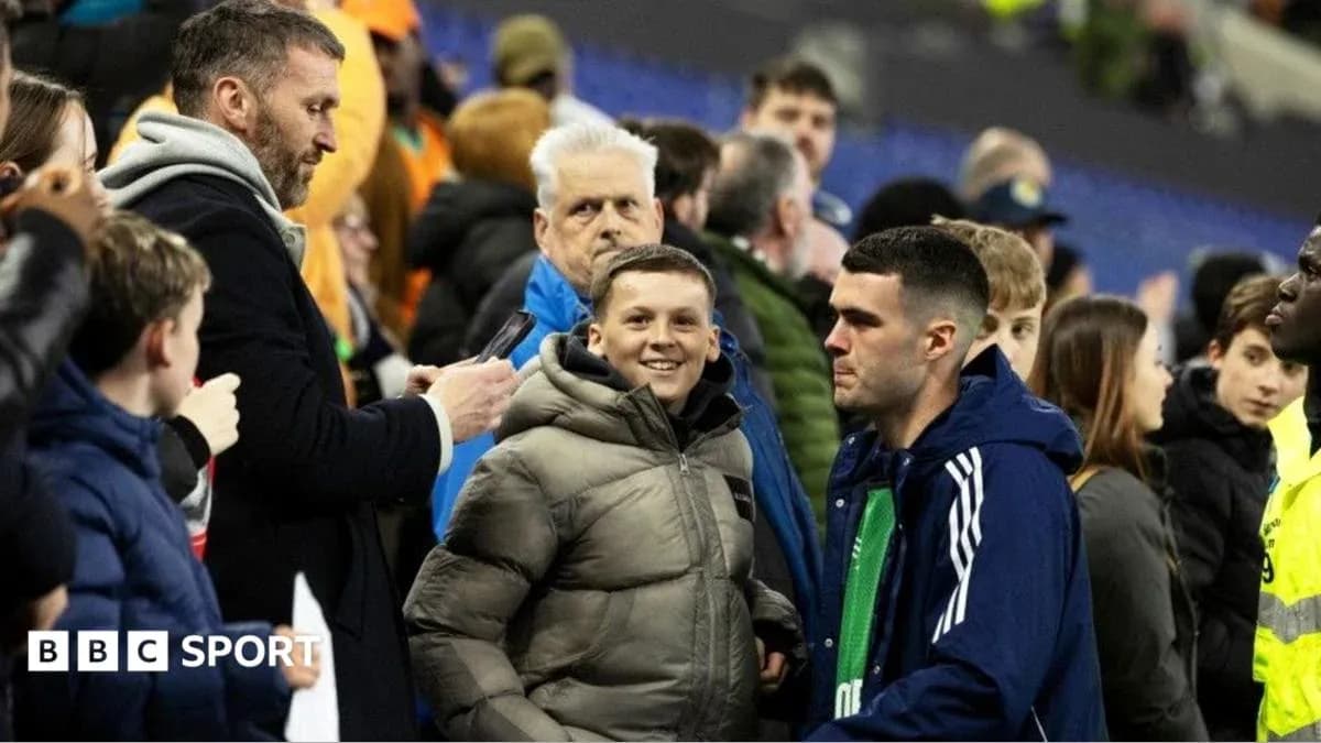 Fans interacting in the stadium stands after match