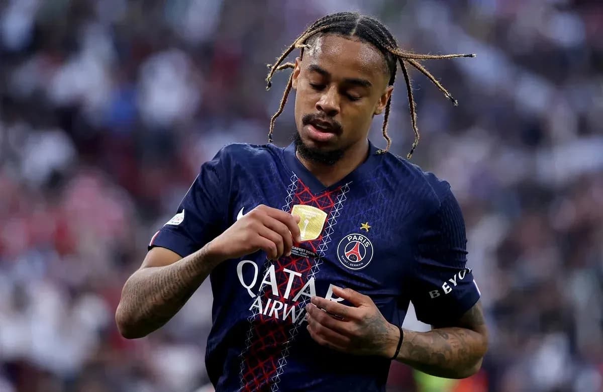 Player inspecting medal on PSG jersey after match