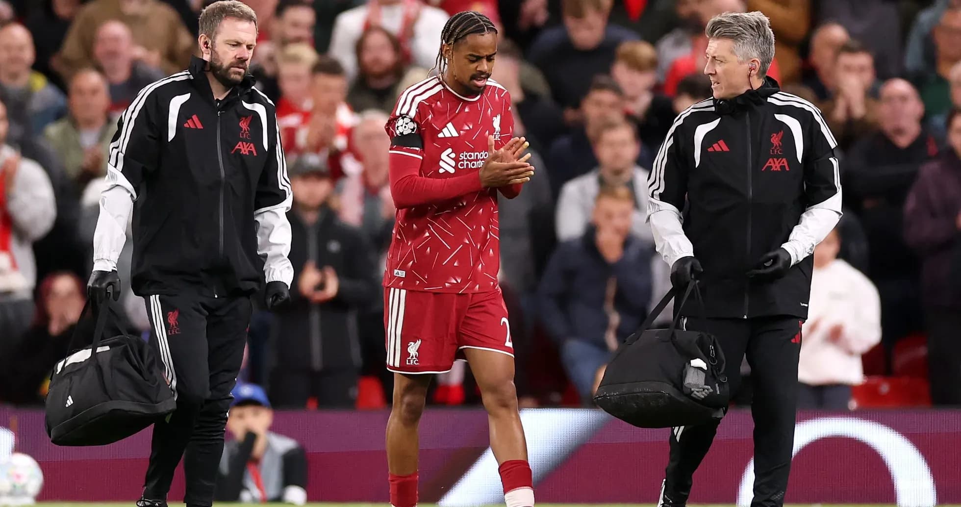 Liverpool player receiving medical attention from staff