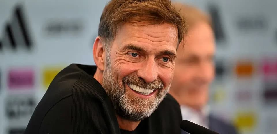 Manager speaking at press conference with smile